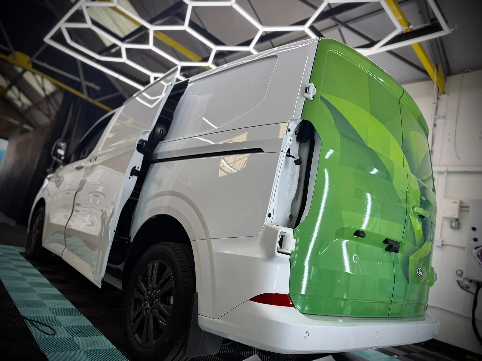 A white Transit Custom part way through its wrap