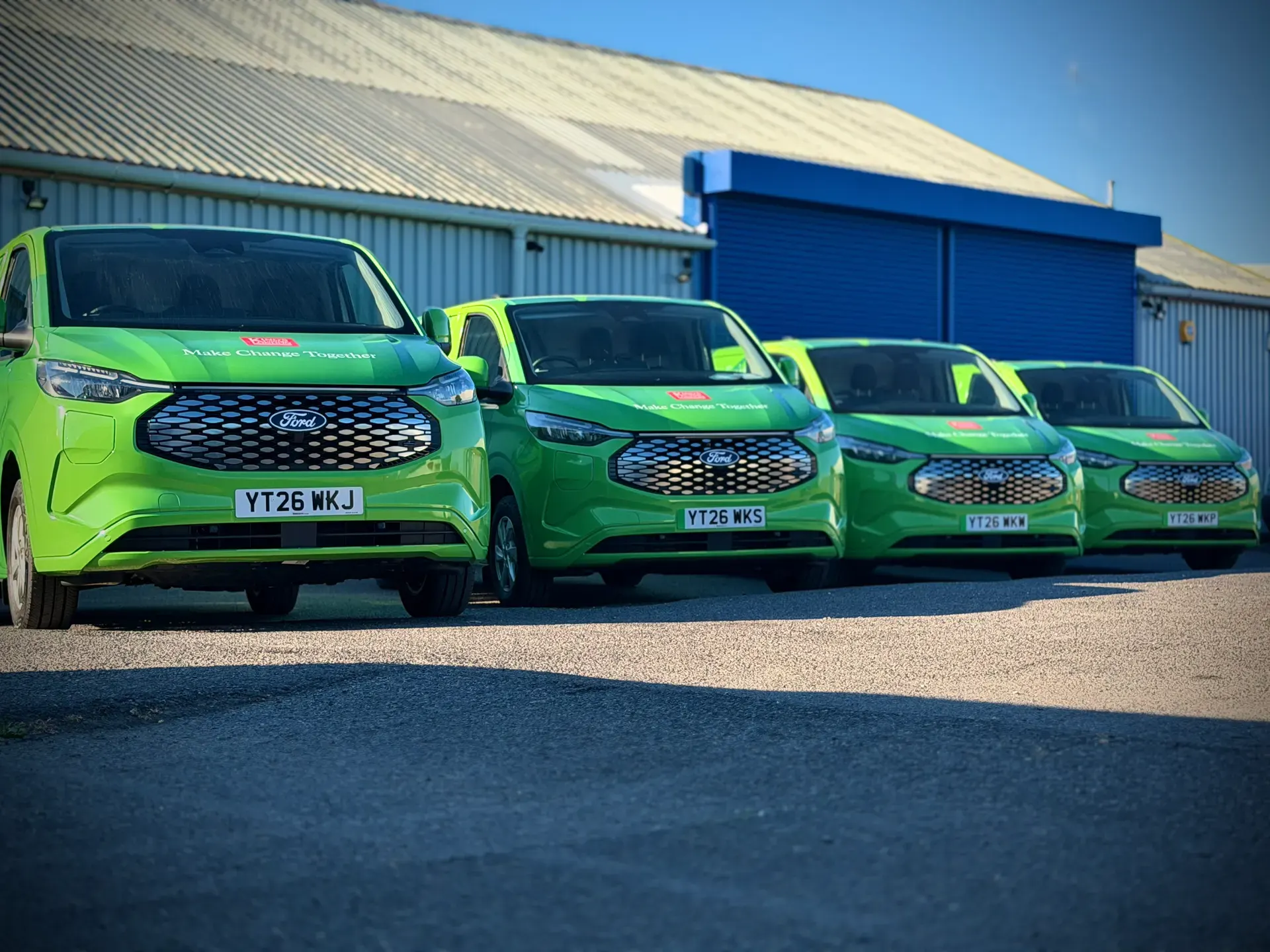 King's College London electric Transit Customs lined up in their full wrap livery