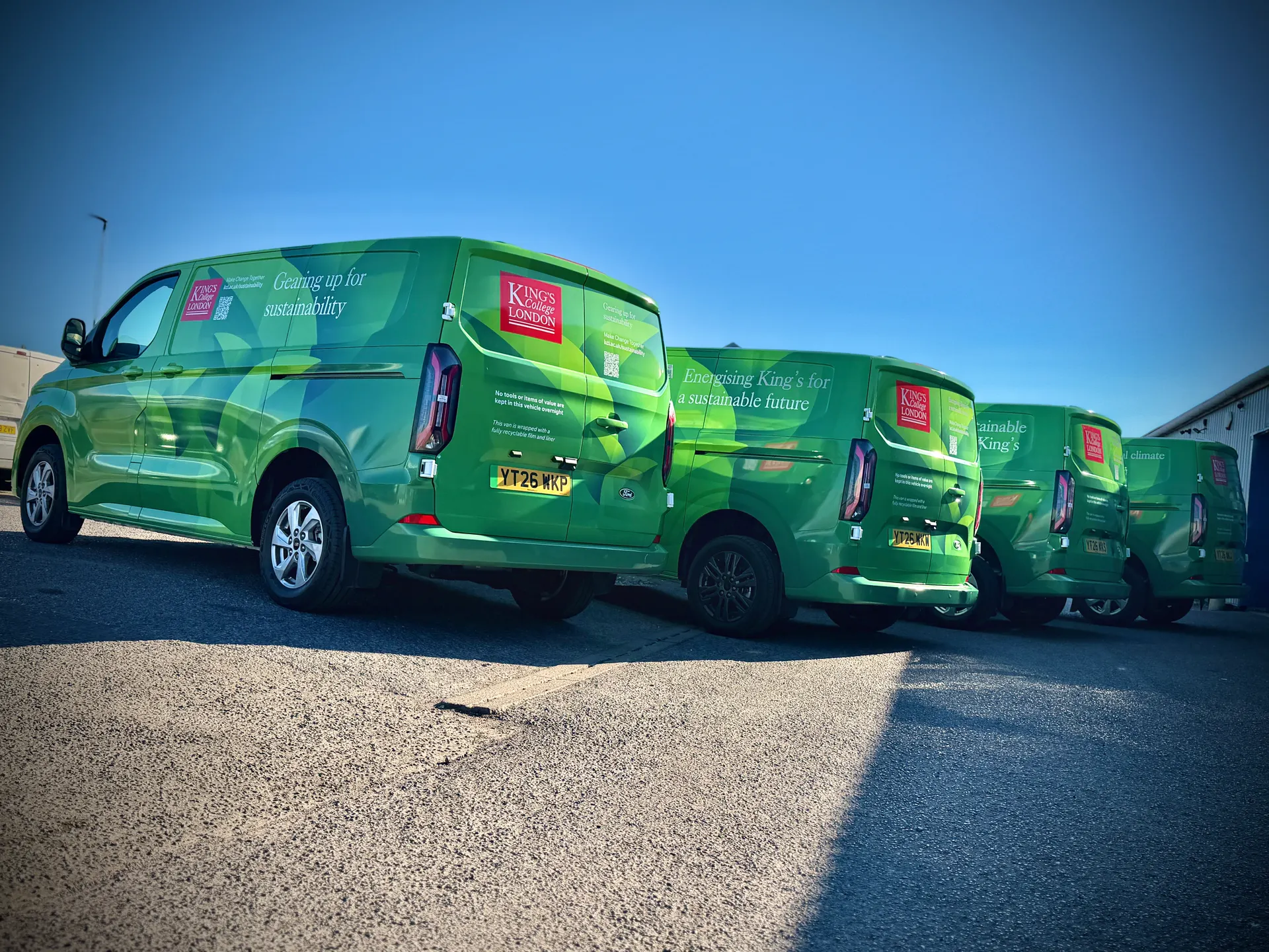 Fleet of King's College London green Ford vans wrapped by P1 Wraps