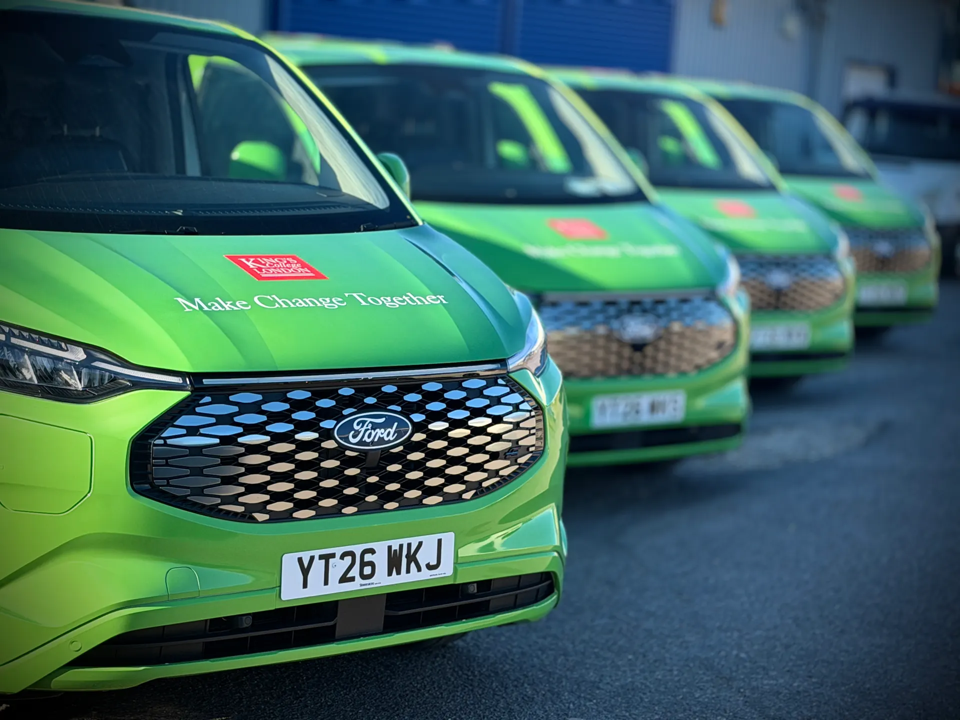 Fleet of King's College London green Ford vans fully wrapped in fleet branding by P1 Wraps
