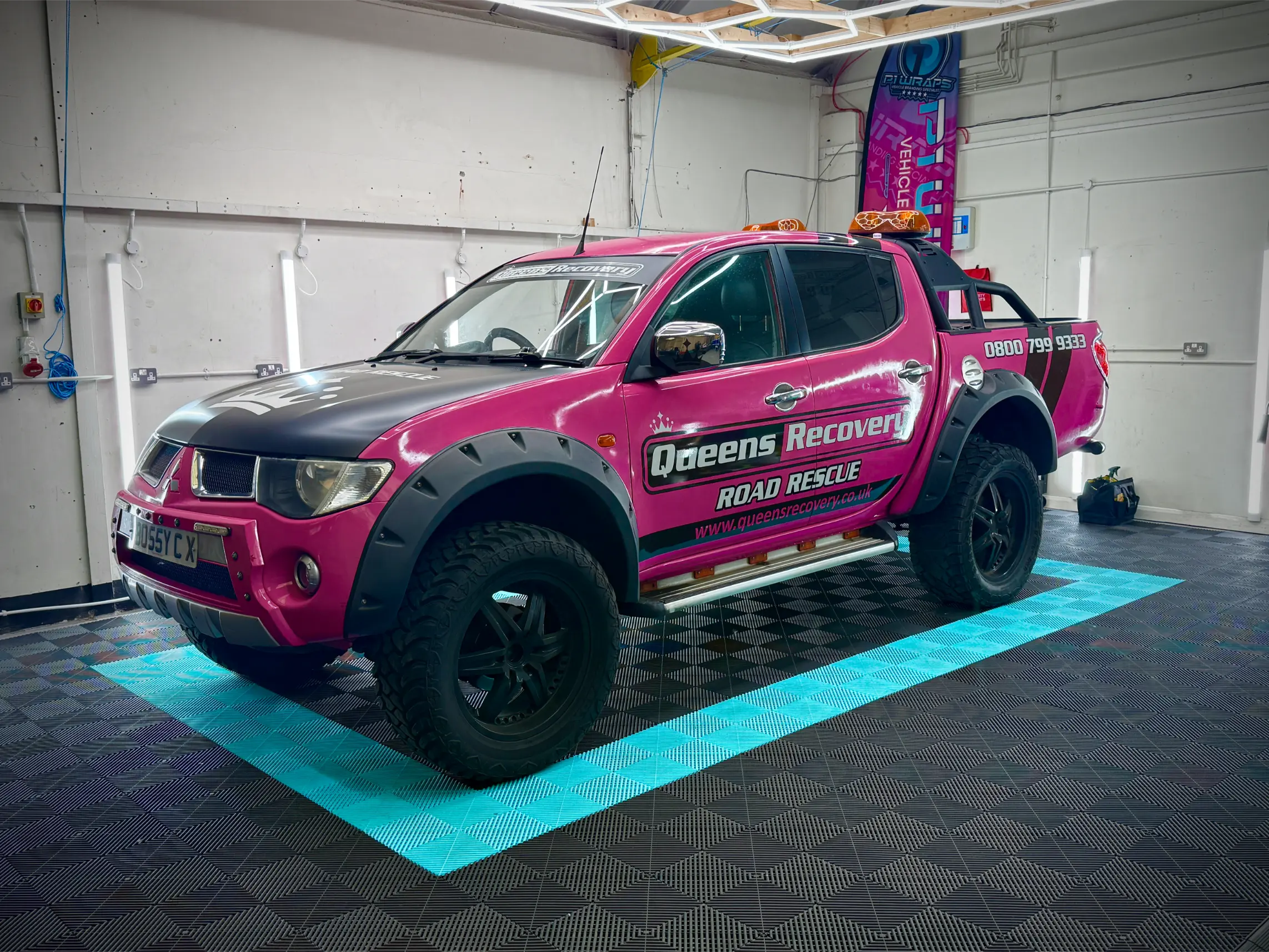 Gerrys Recovery pickup truck with pink and black graphics