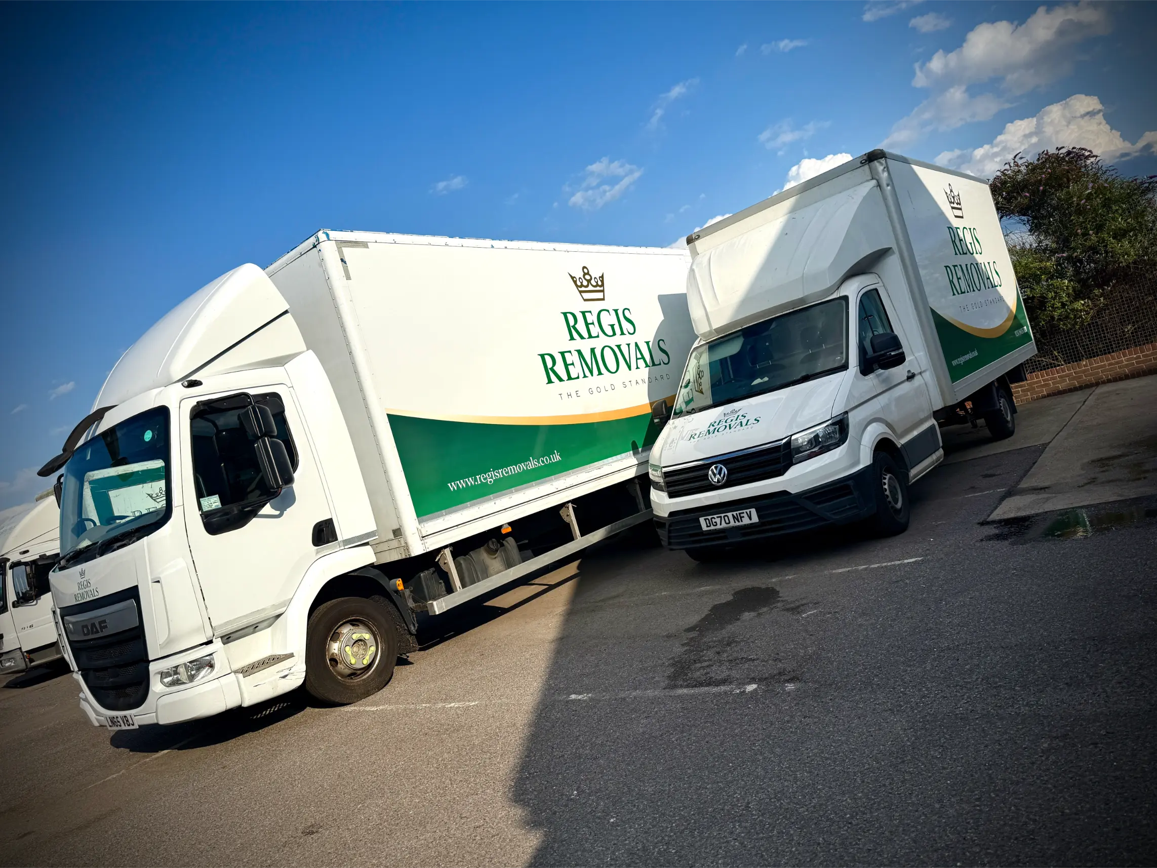 Two Regis Removals trucks with consistent fleet branding