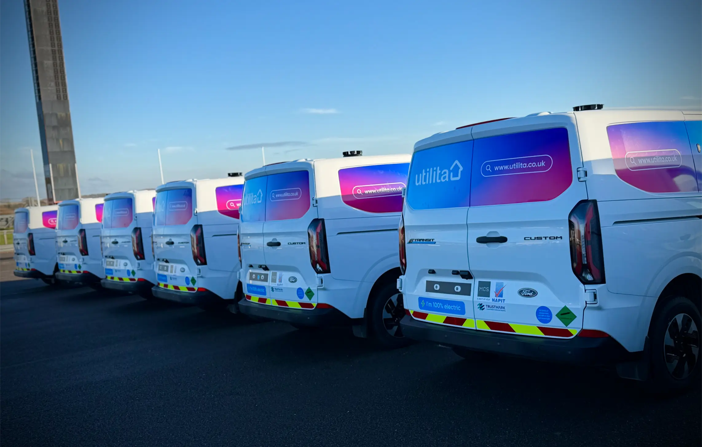 Row of Utilita Ford Transit Custom vans fully wrapped with branded fleet graphics in Hampshire.